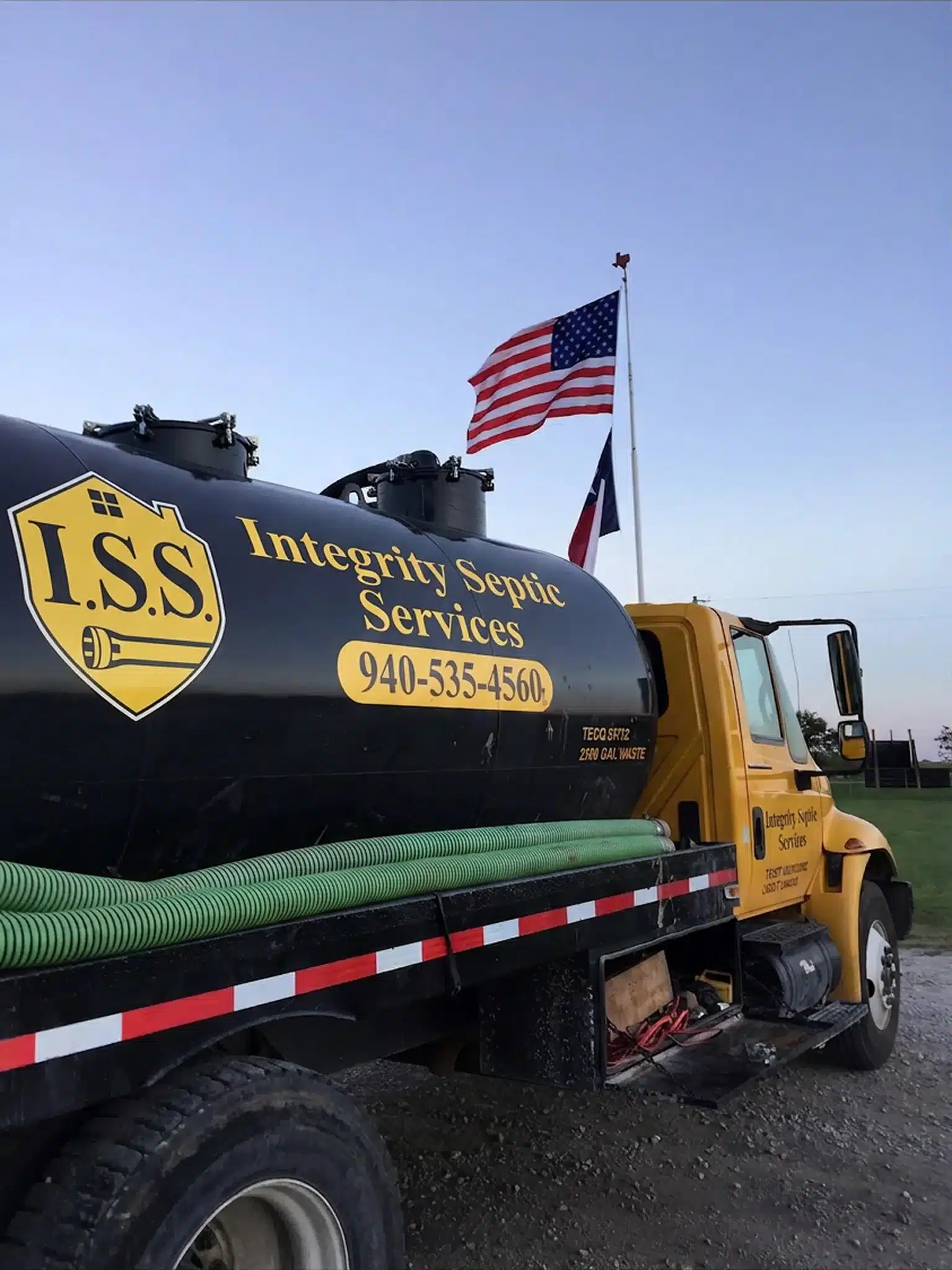 Integrity Septic Services septic pumping truck and American flag, North Texas septic services.